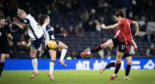 Dominqiue Janssen strikes the ball as Manchester United take on Tottenham in the Barclays WSL