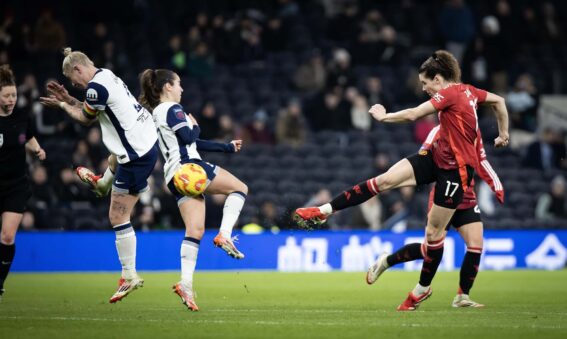 Dominqiue Janssen strikes the ball as Manchester United take on Tottenham in the Barclays WSL